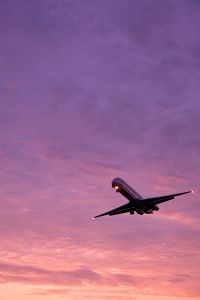An airline landing at sunset. 